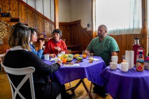 a group of people sitting around a table eating at Re-Crearte Centro Holístico in San Carlos de Bariloche