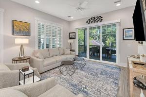a living room with a couch and a table at Moorings 43 in Jekyll Island