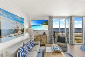 a living room with a couch and a view of the ocean at Villa 129 in Jekyll Island