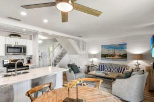 a kitchen and living room with a table and a couch at Villa 129 in Jekyll Island