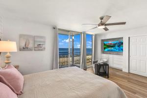 a bedroom with a bed and a view of the ocean at Villa 129 in Jekyll Island +48 photos