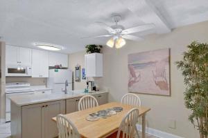 a kitchen with a table and a ceiling fan at Villa 453 in Jekyll Island