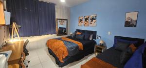 a bedroom with a bed and a couch at Studio Cinza em frente à praia in Aracaju