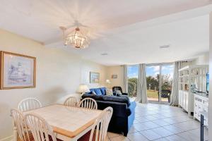 a living room with a table and a couch at Villa 107 in Jekyll Island