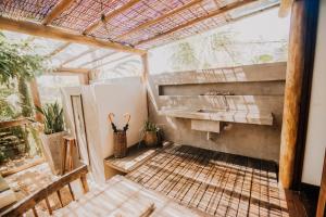 a greenhouse bathroom with a sink and plants at Pousada Casa Mar Pé na Areia in Caraíva +134 photos