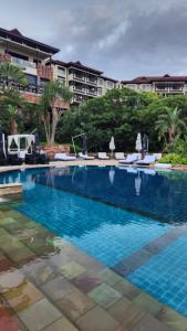 a large swimming pool with blue water in a resort at Zimbali Suites Ocean View Nyambose Villas in Ballito