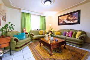 a living room with two couches and a coffee table at Casa Kinich in Guadalajara +54 photos