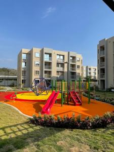 a playground in a park with a slide at Hermoso Apartamento Para Estrenar En Cartagena in Manzanillo del Mar
