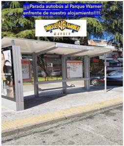 a bus stop with a sign on it at Warner Dreams in San Martín de la Vega