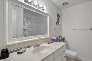 a white bathroom with a sink and a toilet at Villa 452 in Jekyll Island +29 photos