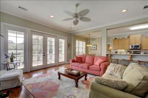 a living room with a couch and a table at Spectacular Sunrise in Jekyll Island