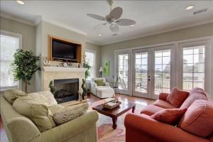 a living room with two couches and a fireplace at Spectacular Sunrise in Jekyll Island
