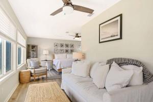 a living room with a couch and a bed at Spring Cottage in Jekyll Island +30 photos
