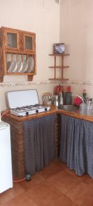 a kitchen with a counter with a stove and a sink at Bungalows Sierra San Benito in Cala