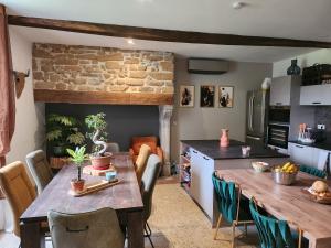 a kitchen with a wooden table and a dining room at La Casa Mora Grande in Asson