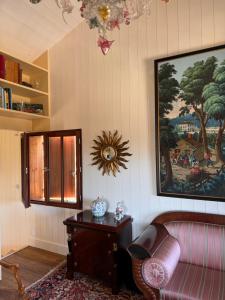 a living room with a couch and a picture on the wall at Cabanon Régina in Lège-Cap-Ferret