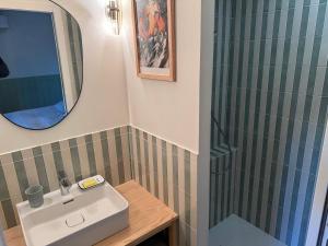 a bathroom with a sink and a shower at Cabanon Régina in Lège-Cap-Ferret +38 photos