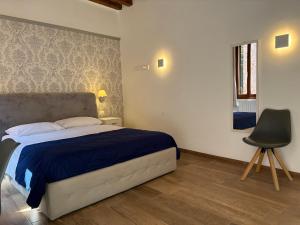 a bedroom with a bed and a chair in it at Casa Giardini in Venice
