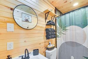 a bathroom with a shower and a sink and a mirror at Hot Tub, Fire Pit Lake-View Catlettsburg Getaway! in Catlettsburg +16 photos