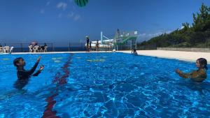two women are swimming in a swimming pool at AJITO in Oshima