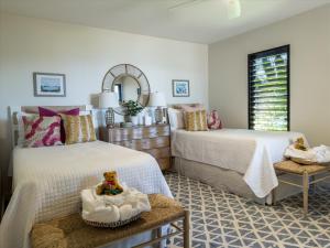 a bedroom with two beds and a mirror at Panoramic Ocean Views! Remodeledredecorated! Very Pretty Corner Ground Floor 2 Bedroom2 Bath in Wailea +32 photos