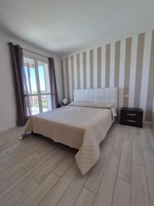 a bedroom with a bed and a wooden floor at A casa di Elena in Lesa +34 photos
