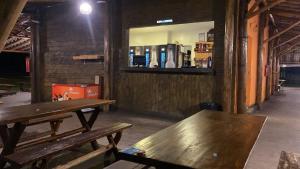 two wooden benches in a room with a window at Villacoco in Pirapora