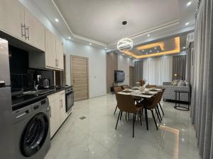a kitchen and dining room with a dining table and a dining roomiasm at Nozoll Boutique Residences in Amman