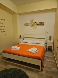 a bedroom with a bed with two towels on it at Bari Vecchia Dimora in Bari