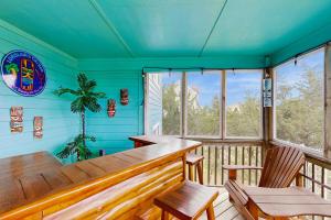 a room with a table and chairs on a deck at Lori's Lair #5-7 in Avon