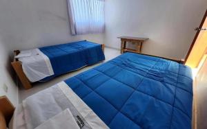 Ένα ή περισσότερα κρεβάτια σε δωμάτιο στο Inka Walker Hostel