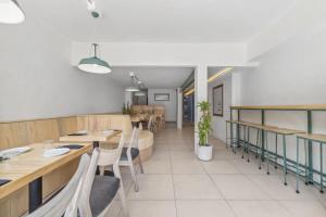 a dining room with wooden tables and chairs at Hotel Emma in Mexico City
