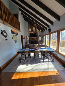 a dining room with a blue table and chairs at Whispering Bears Chalet in Gatlinburg
