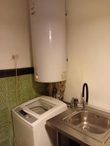a small bathroom with a toilet and a sink at La Verbena House in Viña del Mar