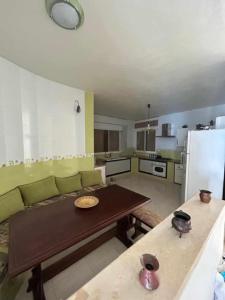 a living room with a green couch and a table at Maison fatha in Kelibia