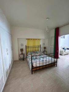 a bedroom with a bed in a room at Maison fatha in Kelibia +5 photos