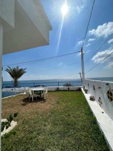 a patio with a table and a view of the ocean at Maison fatha in Kelibia