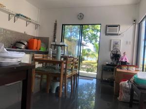 a kitchen with a table and chairs in a room at Sea Breeze Beach House near sandbars and beaches and near to Danao port in Alimañgo