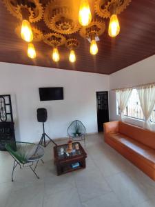 a living room with a couch and a table and lights at Casa Jaguar Viotá in Viotá +31 photos