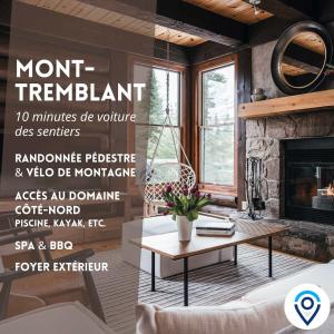 a living room with a table and a fireplace at Family escape w private hot tub in Lac-Superieur