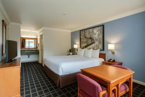 a hotel room with a bed and a desk at Creekside Inn & Suites in Willits +33 photos