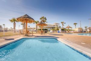 a swimming pool with chairs and umbrellas in a resort at Holiday Inn Club Vacations Galveston Seaside Resort in Galveston
