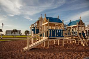 a playground with blue and white wooden play equipment at Holiday Inn Club Vacations Galveston Seaside Resort in Galveston