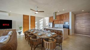 a dining room with a table with wine glasses on it at Beachfront Villa Punta Mita Litibu in Higuera Blanca