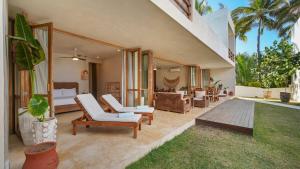 a living room with white chairs and a bedroom at Beachfront Villa Punta Mita Litibu in Higuera Blanca