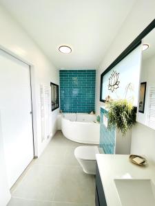 a bathroom with a tub and a toilet and a sink at Villa chic & Zen - Workation - Plage à 10min in Vaux-sur-Mer +43 photos