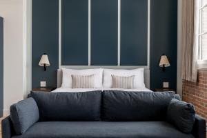 a couch in a room with a bed at The Skowhegan By Kasa in Skowhegan