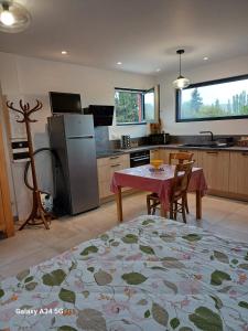 a kitchen with a table and chairs and a refrigerator at nature in Gardanne