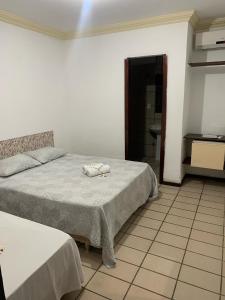 Ένα ή περισσότερα κρεβάτια σε δωμάτιο στο Pousada Pé de Serra