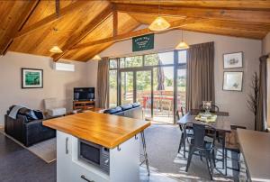 a living room with a kitchen and a dining room at Ski Country Chalet in Ohakune